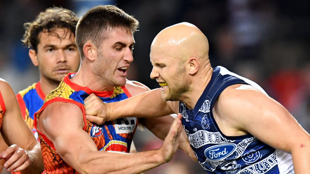 Gary Ablett scuffles with Gold Coast's Anthony Miles.