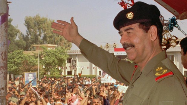 Then Iraqi president Saddam Hussein waves to supporters in Baghdad in 1995.