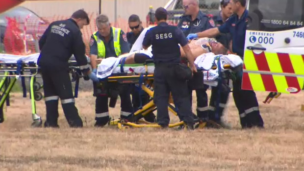 Tony Mokbel is treated by paramedics outside the prison.