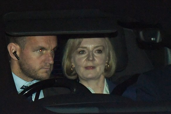 Liz Truss, UK prime minister, right, departs the Houses of Parliament in London on Monday.