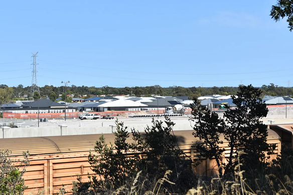 Freight trains go past every half hour or so along the Avon line, with a concrete noise wall built to protect Movida Estate residents from the noise.