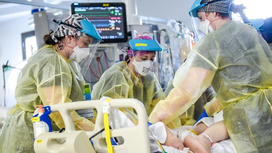 ICU nurses at work on a patient. 