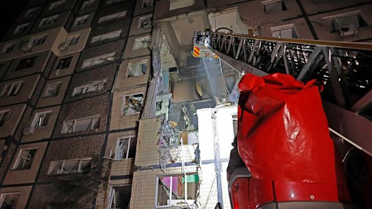 In this photo provided by the Ukrainian Emergency Service, firefighters put out the fire following a Russian rocket attack that hit a multi-storey apartment building in Dnipro, Ukraine, Saturday, Nov. 8, 2025. (Ukrainian Emergency Service via AP)