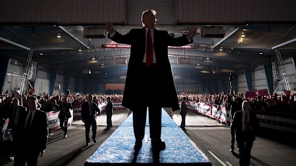 President Donald Trump gestures to the audience as he departs a rally at Southern Illinois Airport in Murphysboro, Illinois.