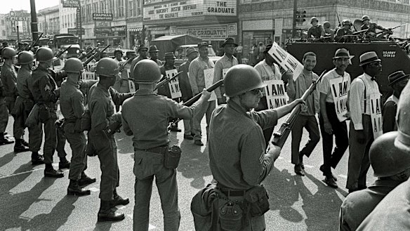 Looking to the past: Striking workers marching past National Guard troops with bayonets during a civil rights march in 1968 in Memphis, Tennessee.