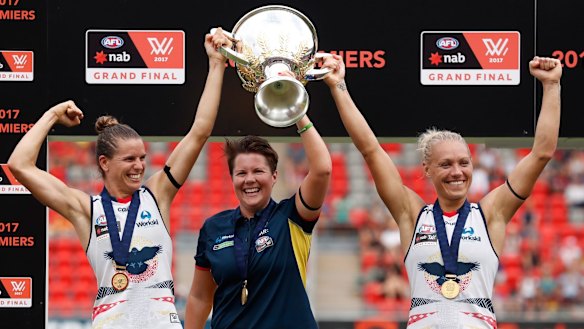 Chelsea Randall, Bec Goddard and Erin Phillip hold the cup aloft.