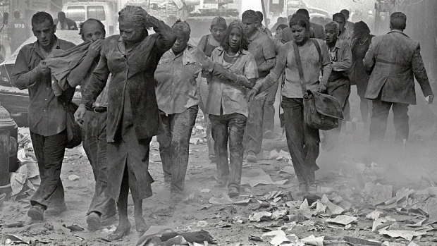 People make their way amid debris after the attack on the World Trade Centre in New York 20 years ago. 