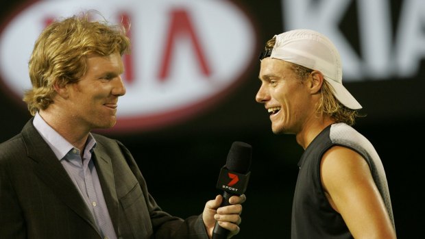Jim Courier chats with Lleyton Hewitt on court at the 2005 Australian Open.