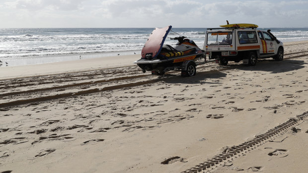 A surf lifesaving crew drives past the scene at Surfers Paradise where a baby's body was found.