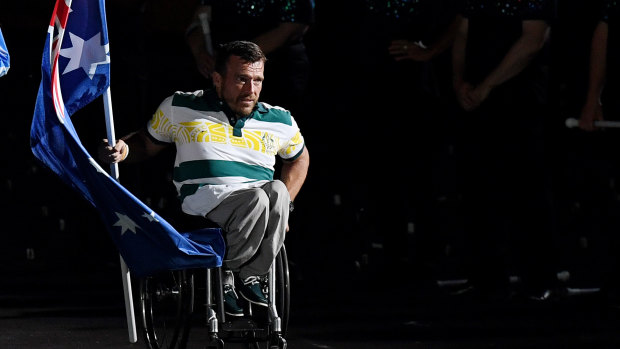 Final act?:  Kurt Fearnley  brings the Australian flag into the Olympic Stadium for the closing ceremony in Sydney. Will this be the last Australia sees of the Games?
