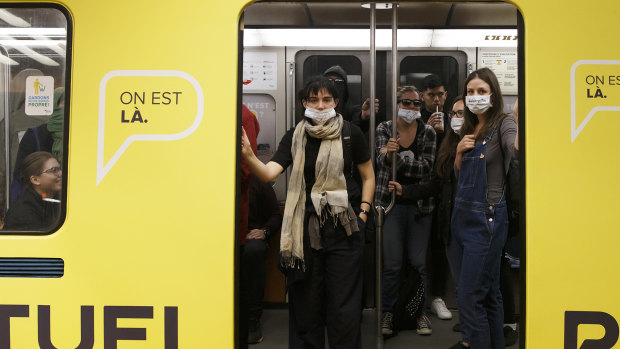 Protesters wear masks and scarves to oppose a law banning people with face coverings from using public transport or working as public employees in  Quebec in 2017. A judge later suspended that law.