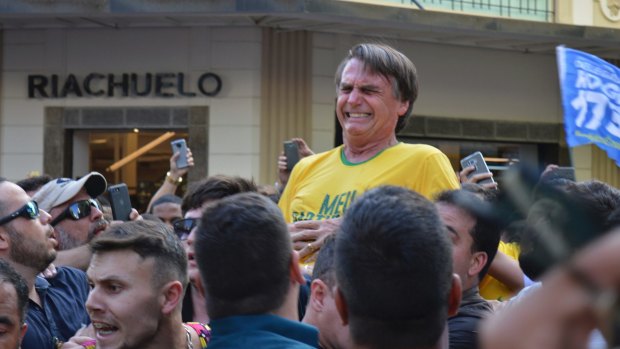 Presidential candidate Jair Bolsonaro grimaces right after being stabbed in the stomach during a campaign rally in Juiz de Fora.