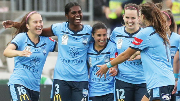 Sydney FC celebrate their route after Shadeene Evans (second left) scores their third in injury time.