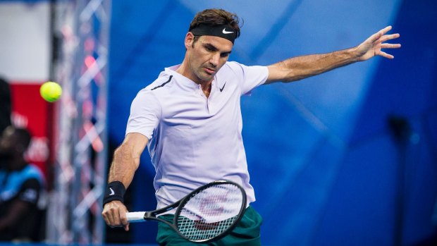Roger Federer returns with a backhand against Yuichi Sugita of Japan on the first day of the 2018 Hopman Cup.