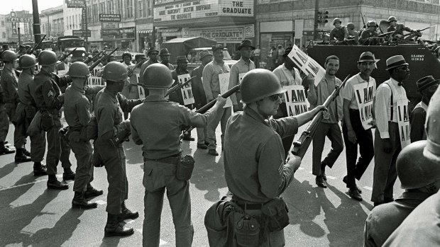 Looking to the past: Striking workers marching past National Guard troops with bayonets during a civil rights march in 1968 in Memphis, Tennessee.