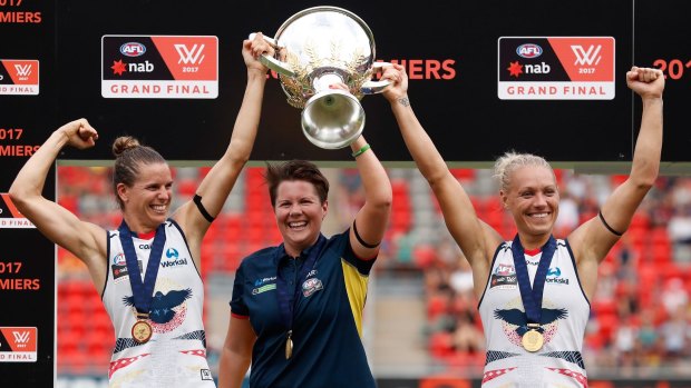 Chelsea Randall, Bec Goddard and Erin Phillip hold the cup aloft.