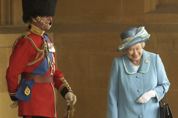 Queen Elizabeth II and Prince Philip prior to The Queen’s Company Grenadier Guards ceremonial review at Windsor Castle in 2003. The photographer has revealed what the royal couple was laughing at.