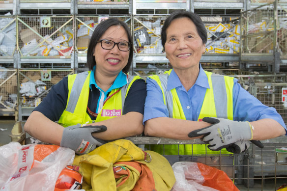 Sorting out your Christmas: Australia Post mail officer Gladys Lawang (left) works with her mother Cora Andres at Australia Post's Melbourne Gateway Facility at Melbourne Airport.