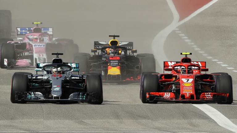 Drought-breaker: Ferrari's Kimi Raikkonen (right) passes Lewis Hamilton during the F1 Grand Prix in Texas.