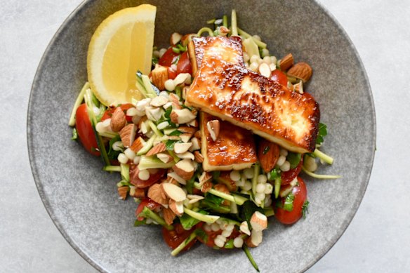 Simple ingredients star in this salad, which tops pearl couscous, zucchini and almonds with golden halloumi.