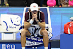 Alex De Minaur of Australia reacts after retiring injured.
