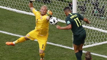 Denmark goalkeeper Kasper Schmeichel denies Australia's Andrew Nabbout.