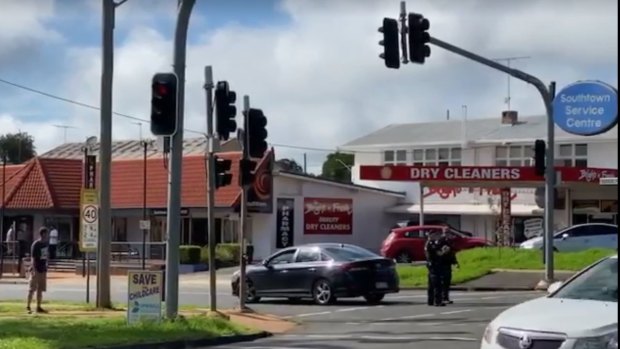 Police outside the school and shopping centre in Centenary Heights on Friday morning.
