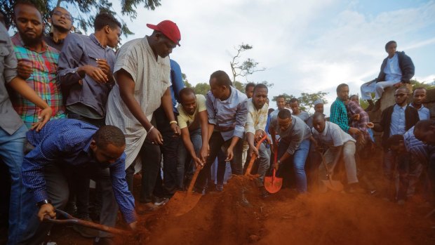 Mourners bury the body of a victim of the attack.