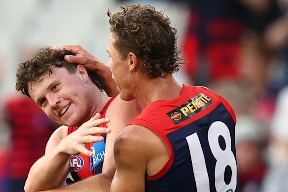 Harvey Langford (left) of the Demons celebrates a goal.