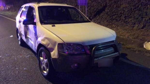 Police smashed through the vehicle's window to pull the driver out / the Ford Territory was badly damaged / A spare tyre was dragged behind the SUV, causing sparks to fly along the M1
