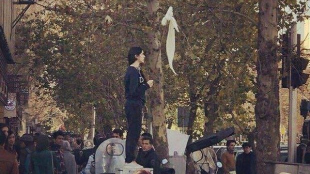 Women in Iran have been protesting against laws forcing them to wear veils by posting pictures on social media holding their headscarves high.
