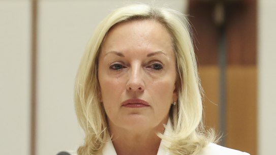 Christine Holgate takes her seat at the start of a hearing on Australia Post at Parliament House in Canberra.