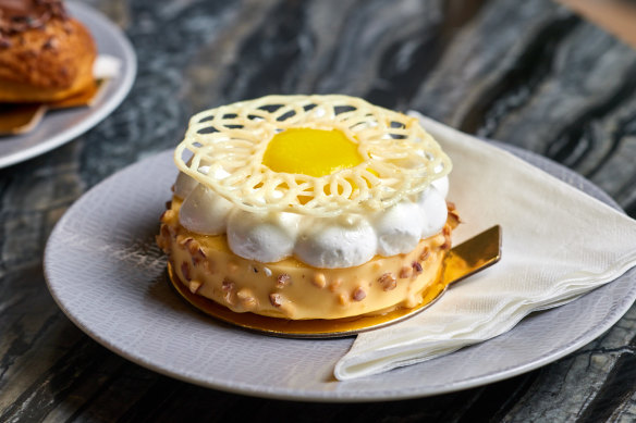 Lemon meringue tart with lemon curd, almond dacquoise, roasted almond and white chocolate glaze.