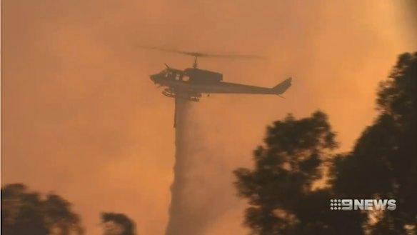 Petrol station razed in bushfire north of Perth as heatwave sets in