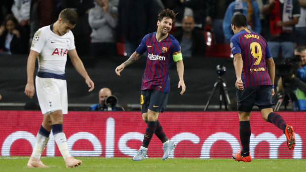 Maestro: Barcelona forward Lionel Messi (centre) celebrates after scoring his side's third goal against Spurs.