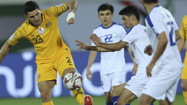 Australian midfielder Tom Rogic, left, will be forced to sit out the next match after receiving a bizarre yellow card.