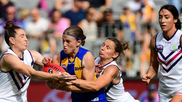 Mikayla Bowen of the Eagles is tackled by Kiara Bowers of the Dockers.