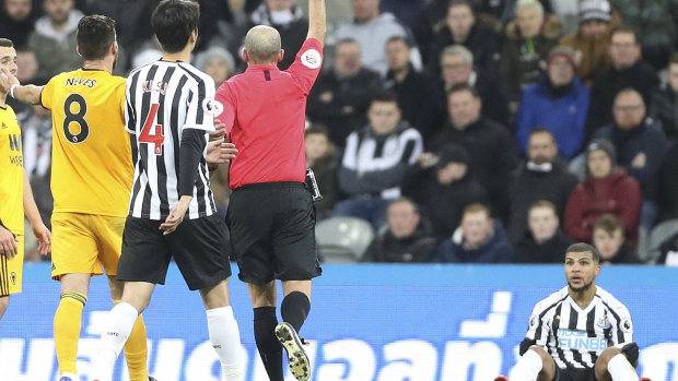 Dismissed: Newcastle United's DeAndre Yedlin (right) is shown a red card by referee Mike Dean.