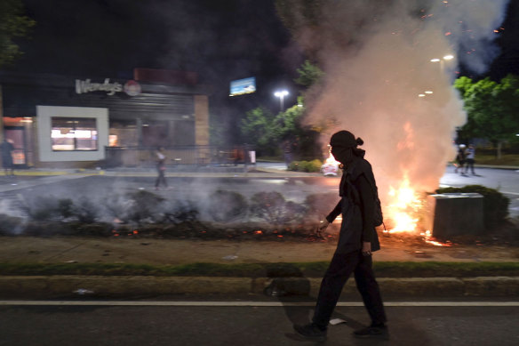 A Wendy's restaurant burns on Saturday, June 13 in Atlanta after protests blocked highway traffic. 