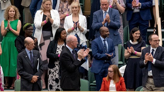 Royals and spectators stand for Sarah Gilbert, seated at bottom right, one of the creators of the Astra Zeneca vaccine, in the Royal Box at Wimbledon’s Centre Court. 