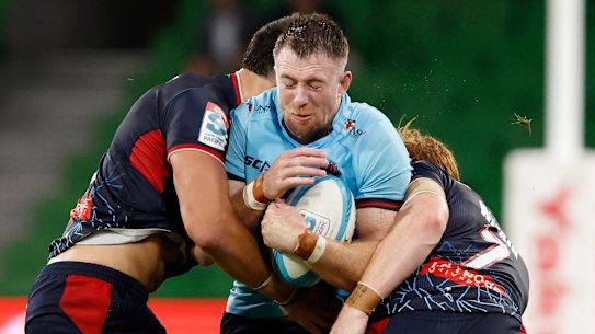 MELBOURNE, AUSTRALIA - MARCH 10: Jed Holloway of the Waratahs is tackled during the round three Super Rugby Pacific match between Melbourne Rebels and NSW Waratahs at AAMI Park, on March 10, 2023, in Melbourne, Australia. (Photo by Darrian Traynor/Getty Images)