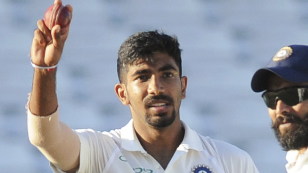 Dominant: India's Jasprit Bumrah raises the ball after taking his fifth wicket.