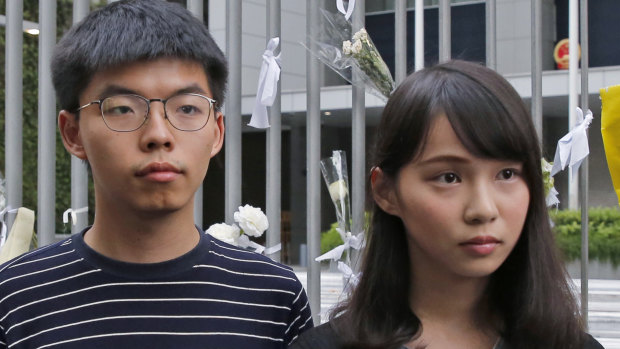 Pro-democracy activists Agnes Chow, right, and Joshua Wong meet media in June outside government offices in Hong Kong. 