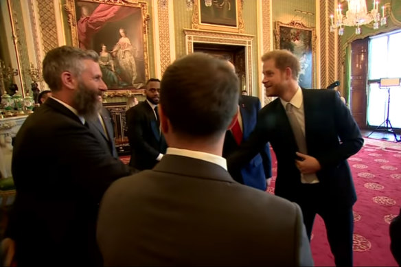 The Duke of Sussex (right) chats with Adam Hills about his beard before the draw.