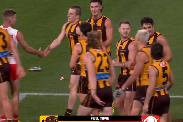 A soft drink bottle on the field as Hawthorn celebrates Thursday night’s win over Sydney.