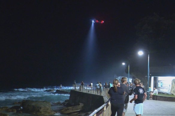 Emergency crews search the waters off Bronte Beach on Sunday night.