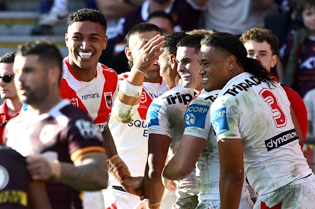 BRISBANE, AUSTRALIA - MAY 31: Setu Tu of the Dragons is congratulated by team mates after scoring a try during the round 13 NRL match between Brisbane Broncos and St George Illawarra Dragons at Suncorp Stadium, on May 31, 2026, in Brisbane, Australia. (Photo by Bradley Kanaris/Getty Images)