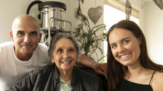 Rod, Alice and Marlee Silva looking through family photo albums.