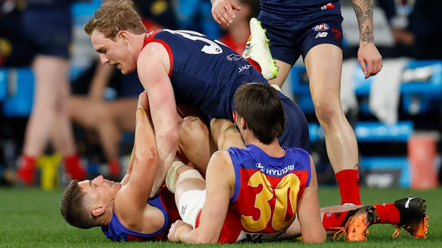 Dayne Zorko of the Lions and Harrison Petty of the Demons clash during the 2022 second semi-final match at the Melbourne Cricket Ground.