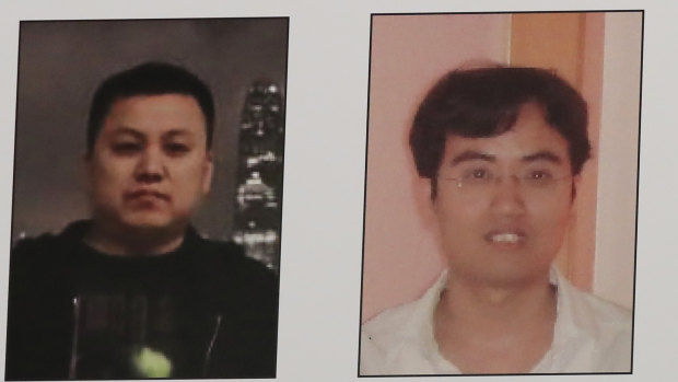 A poster displayed during a news conference at the Department of Justice in Washington shows two Chinese citizens suspected of being with the group APT 10 carrying out an extensive hacking campaign to steal data from US companies. 